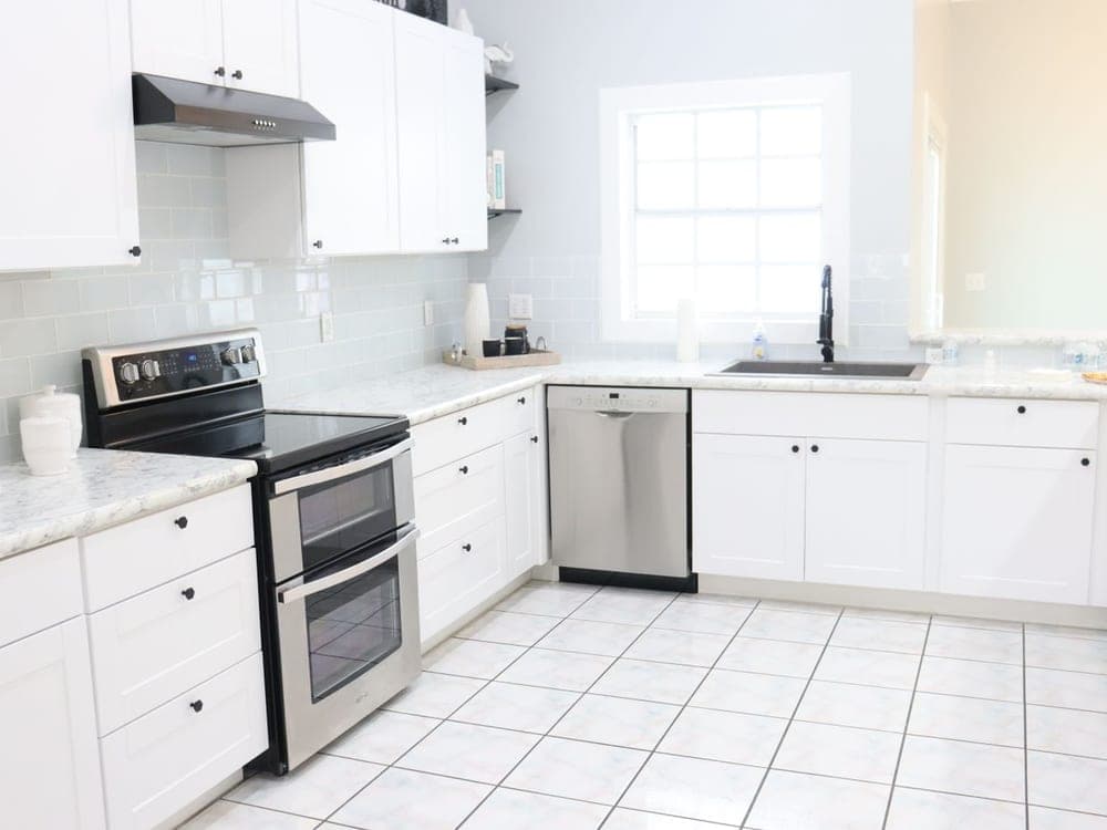 The same style of kitchen after a deep clean, gleaming worktops